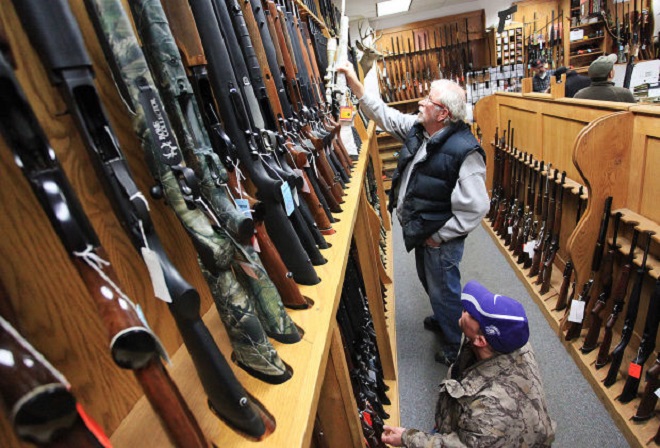 Jeff Torgerson, top, and Dan Volkman, both of Minneiska, Minn., browse the selection of rifles Wednesday, Jan. 16, 2013, at Mainstream Firearms and Marine in Winona. President Barack Obama announced a plan Wednesday to reform national gun laws. (Andrew Link/Winona Daily News)