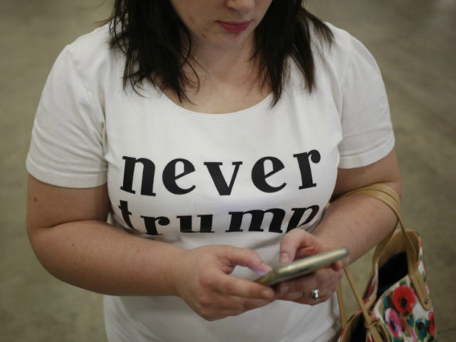 An attendee wears a "Never Trump" shirt during a campaign event for Donald Trump, president and chief executive of Trump Organization Inc. and 2016 Republican presidential candidate, not pictured, in Indianapolis, Indiana, U.S., on Wednesday, April 20, 2016. Trump and Hillary Clinton won their New York presidential primaries Tuesday, ending losing streaks for both campaigns and allowing the two front-runners to reassert control over their party nominating fights. Photographer: Luke Sharrett/Bloomberg